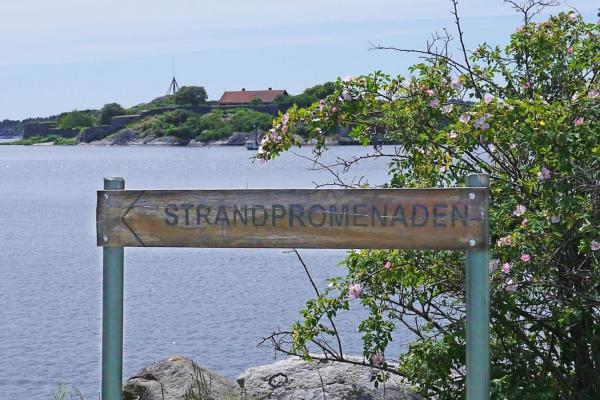 Wooden sign and view of the sea and Kastellet