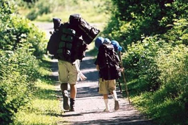 Two hikers with packing