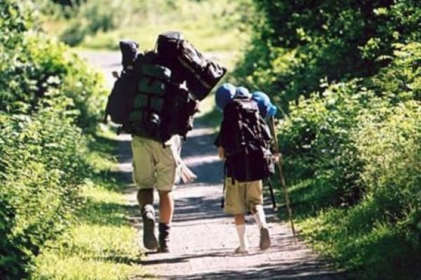 Two hikers with packing
